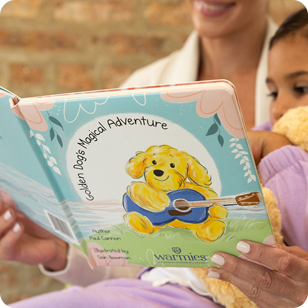Image 88: little girl and mom reading Golden Dog's Magical Adventure warmies book