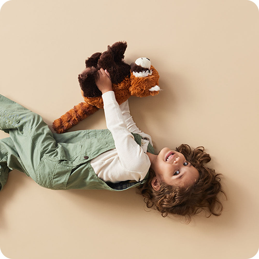 Image 100: girl holding red panda stuffed animal