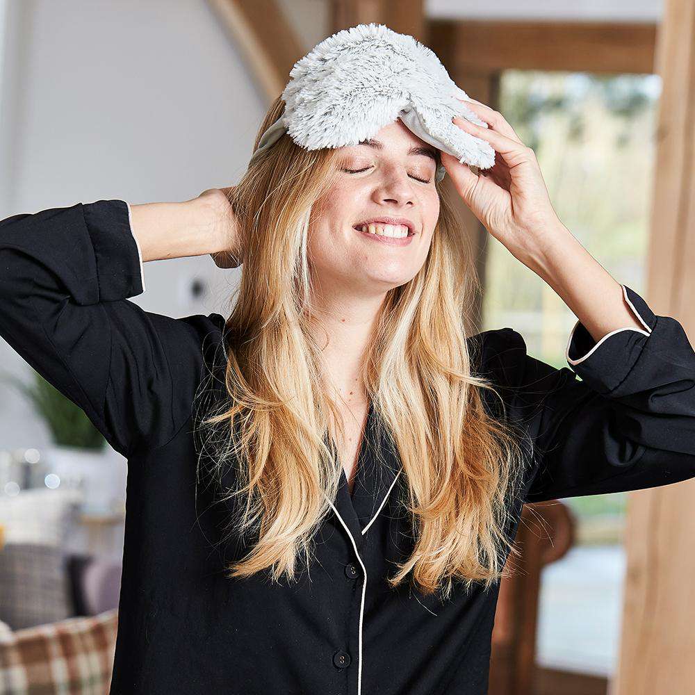 Image 91: Woman smiling while wearing Microwavable Marshmallow Eye Mask: Cozy comfort for serene relaxation.