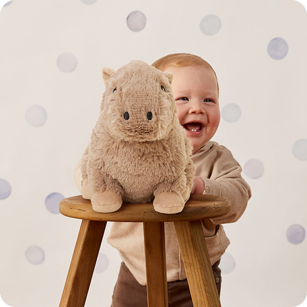 Image 103: baby laughing with capybara stuffed animal warmies