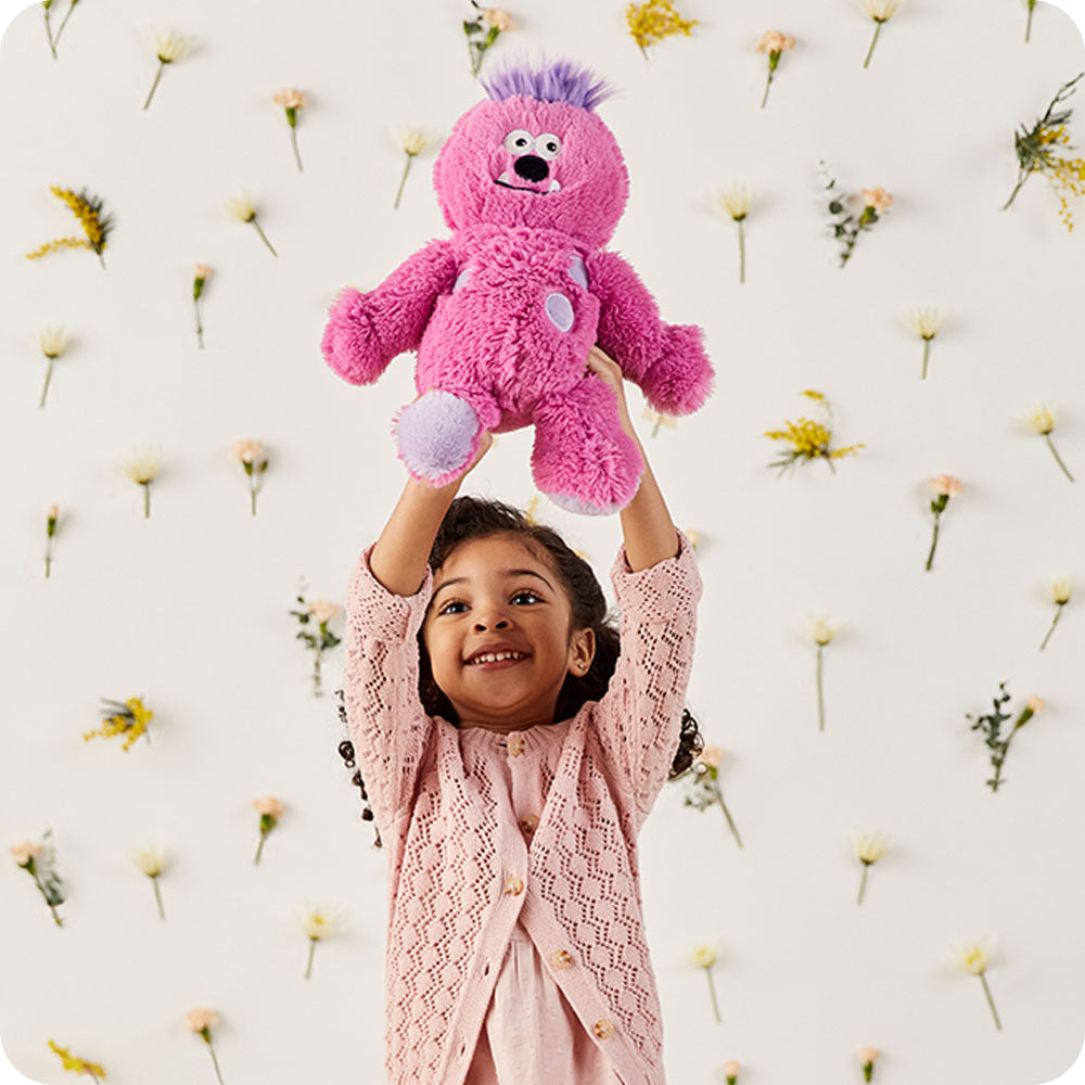 Image 104: girl holding pink monster stuffed animal