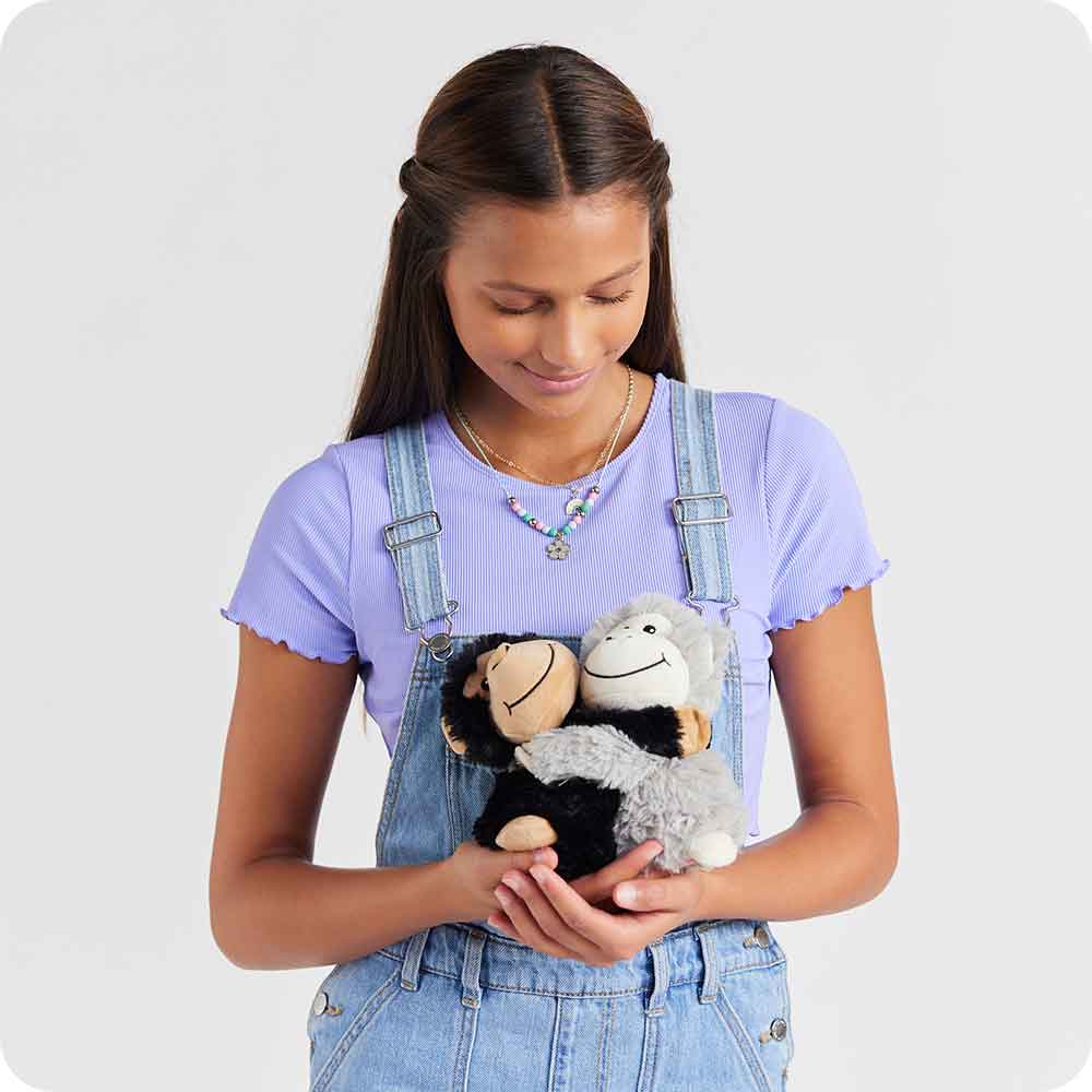 Image 102: Teenager holding Soft Warm Weighted Lavender Scented Monkey Hugs Plush Warmies