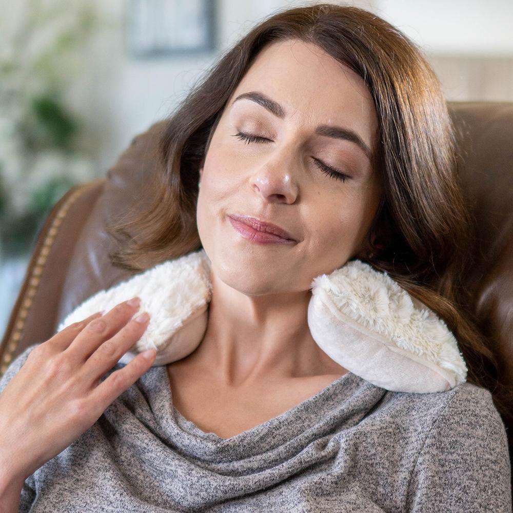 Image 91: Woman relaxing with Cozy Microwavable Cream Warmies Neck Wrap.