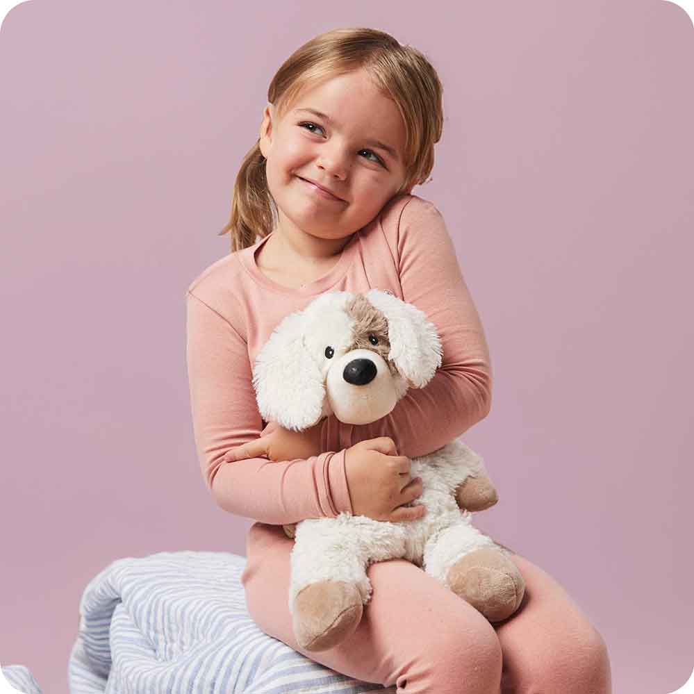 Image 102: Girl hugging Soft Warm Weighted Puppy Warmies
