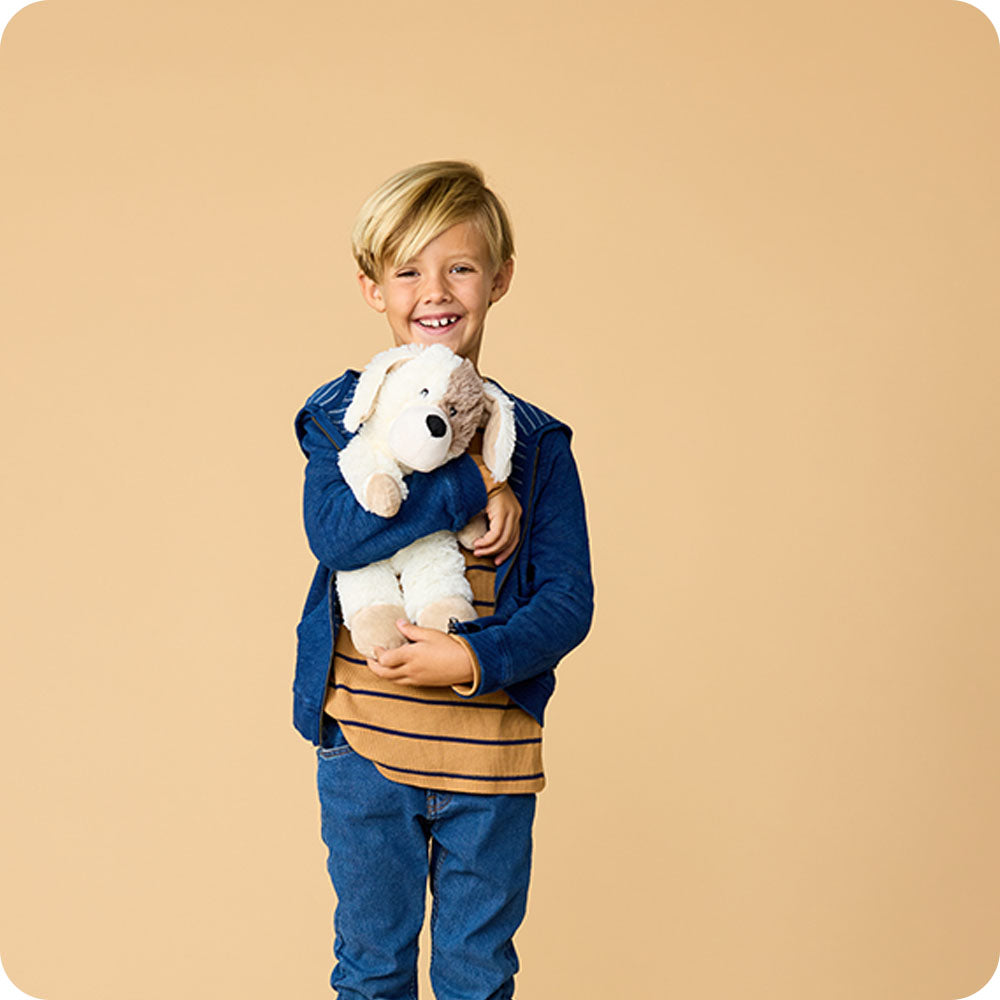 Image 103: boy holding puppy stuffed animal
